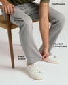 Man wearing Medium Gray Wash Straight Comfort Stretch Jeans, demonstrating fabric's stretch.