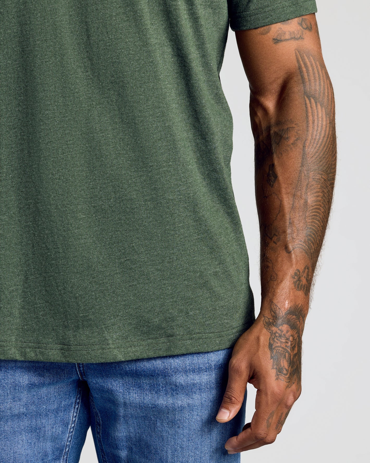 Dark Heather Olive Classic Crew Neck on tattooed arm and torso.