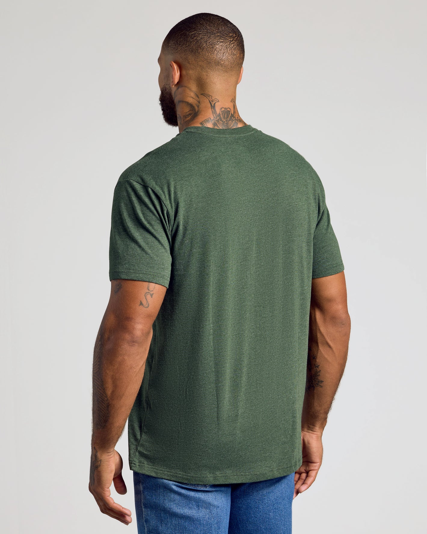 Man wearing Dark Heather Olive Classic Crew Neck T-shirt, back view.