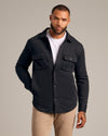 Black Fleece Shirt Jacket with chest flap pockets, layered over white T-shirt.