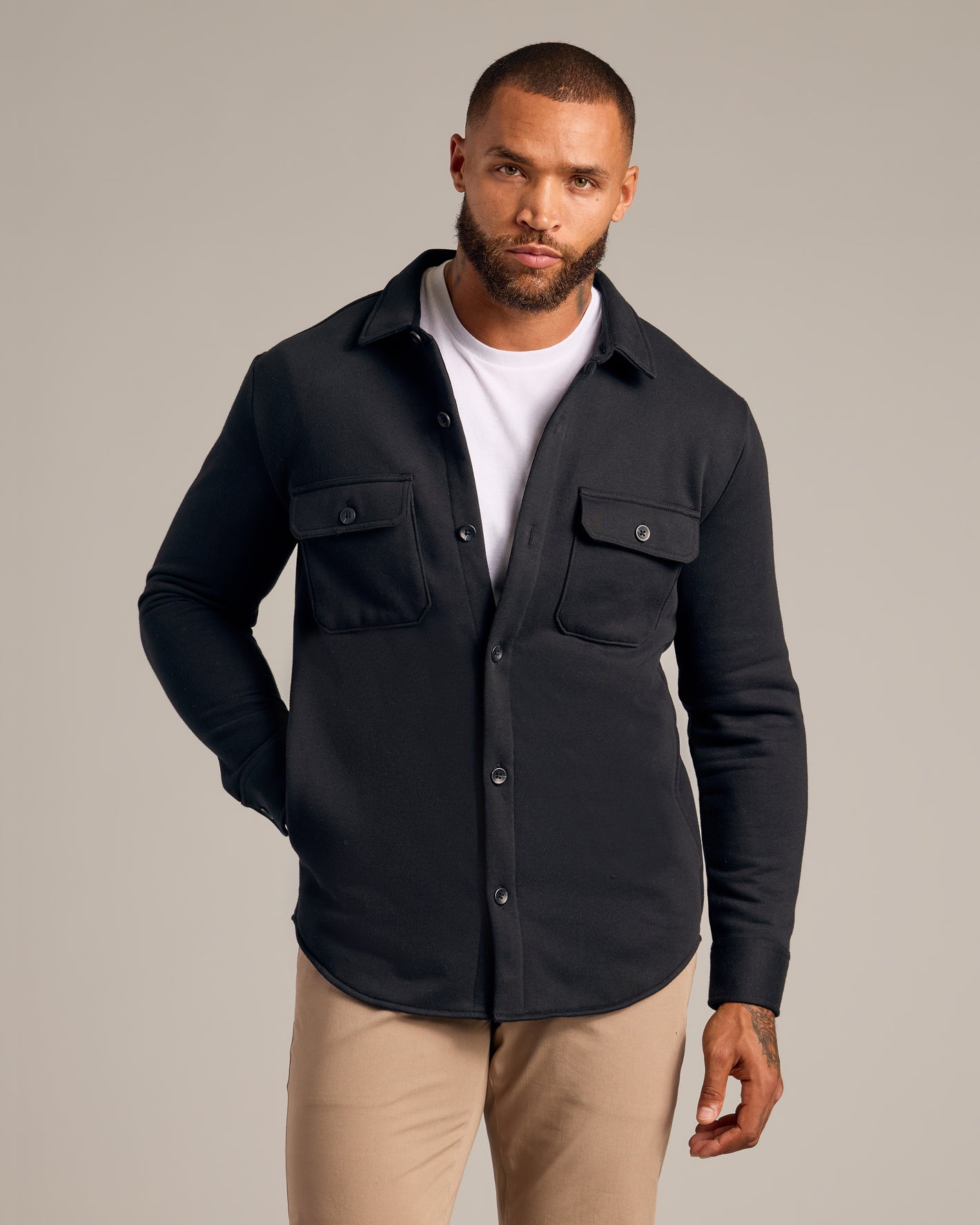 Black Fleece Shirt Jacket with chest flap pockets, layered over white T-shirt.