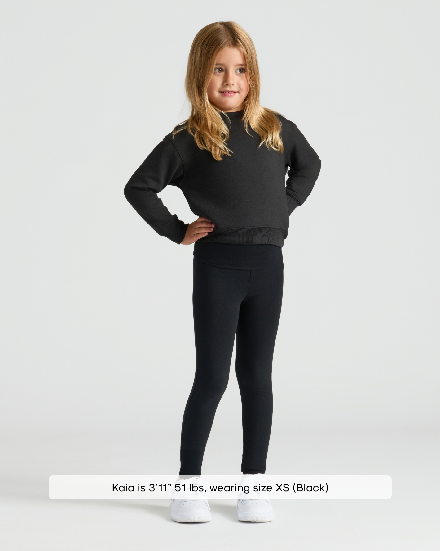 Girl wearing Girls Black Slouch Pullover Crew with leggings and sneakers.