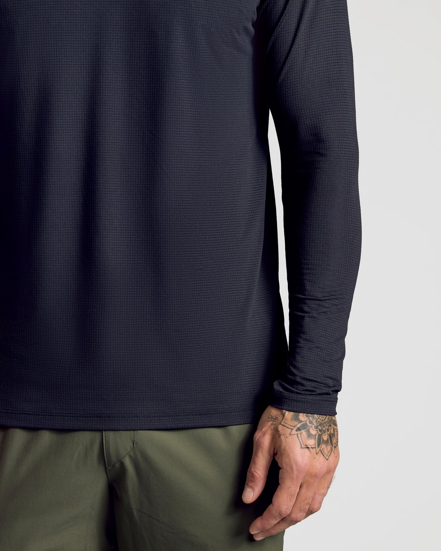 Black Long Sleeve Active Mesh Crew with tattooed hand visible.