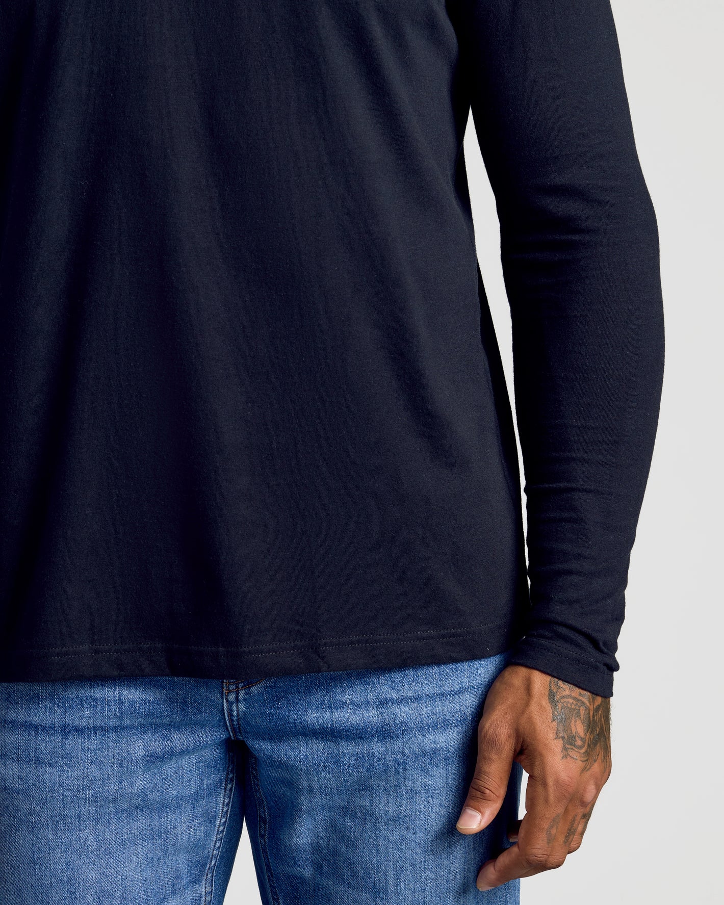 Standard Long Sleeve Crew 3-Pack, black shirt, tattooed hand visible.