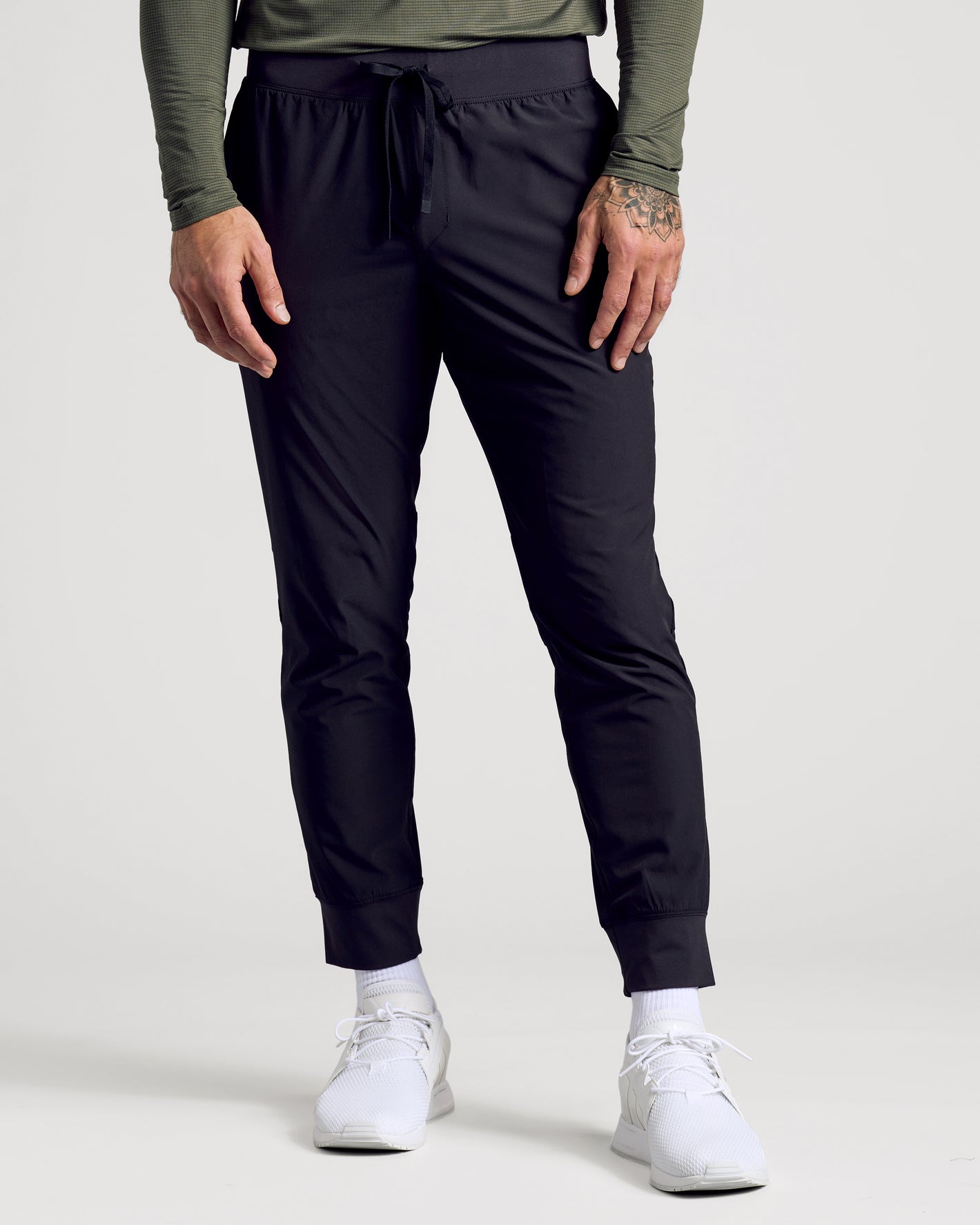 Black Active Training Joggers with elastic waist, ribbed cuffs, and sneakers.