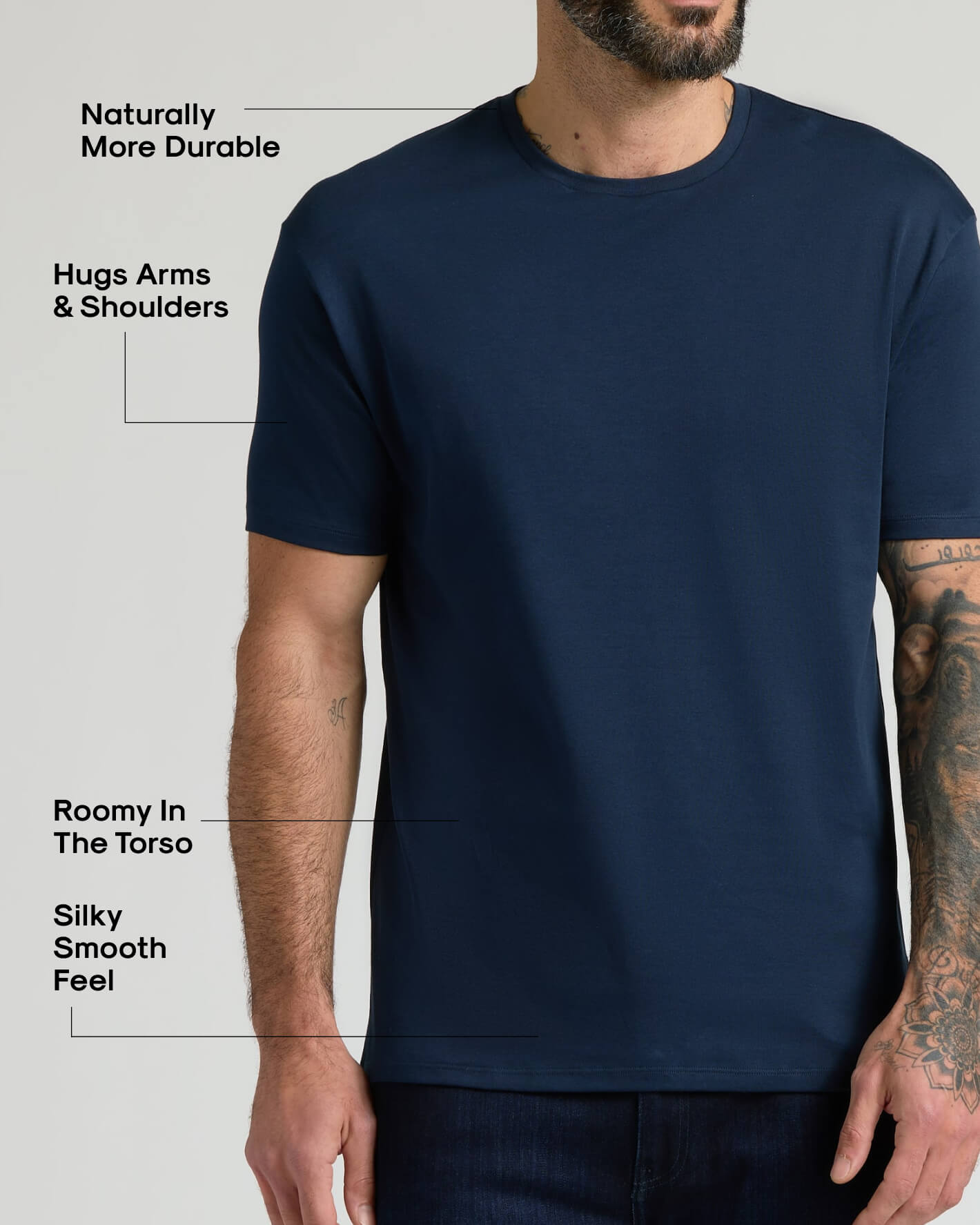 Man wearing a navy blue Pima Cotton Blend Crew 4-Pack t-shirt highlighting its natural durability, comfortable fit that hugs arms and shoulders, roomy torso, and silky smooth feel.