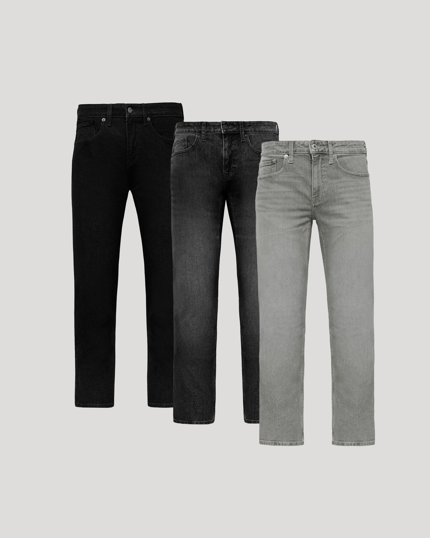 Three pairs of jeans in black, gray, and light gray on a light gray background