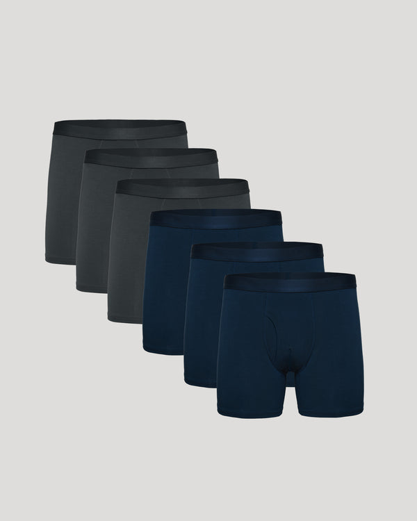 Set of six pairs of men's underwear in black and navy on a light gray background