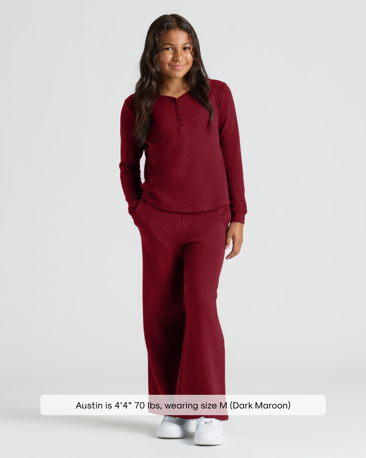 Girl in maroon waffle wide-leg pants with Henley top.