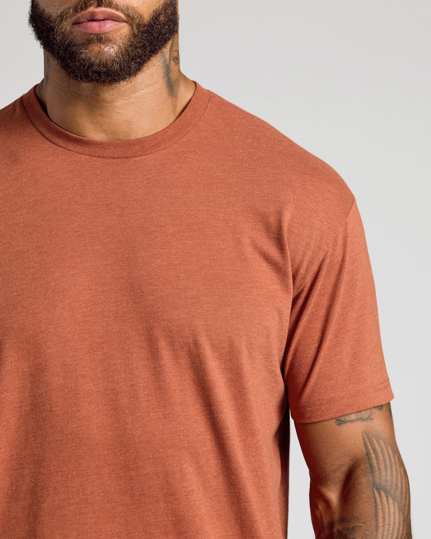 Heather Gingersnap Classic Crew Neck on tattooed man, highlighting short sleeves.