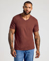 Male model in Dark Chocolate Classic V-Neck and jeans, showcasing tattoos.