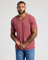 Man wearing Rustic Apple Classic V-Neck T-shirt with tattoos visible.
