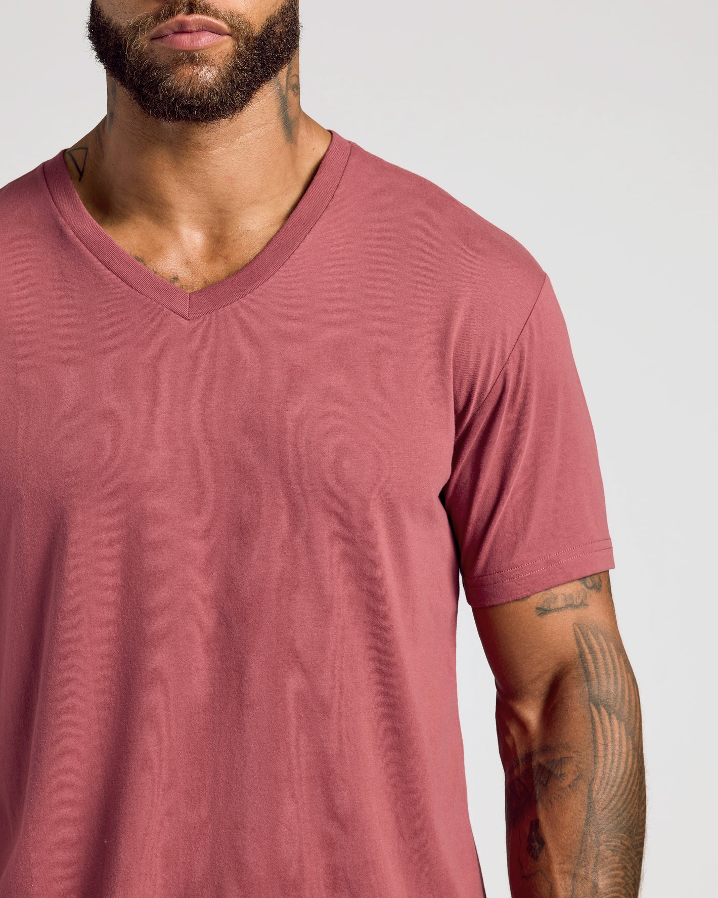Rustic Apple Classic V-Neck on bearded man with tattoos.