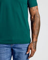 Person wearing the Viridian Classic V-Neck with tattooed forearm.