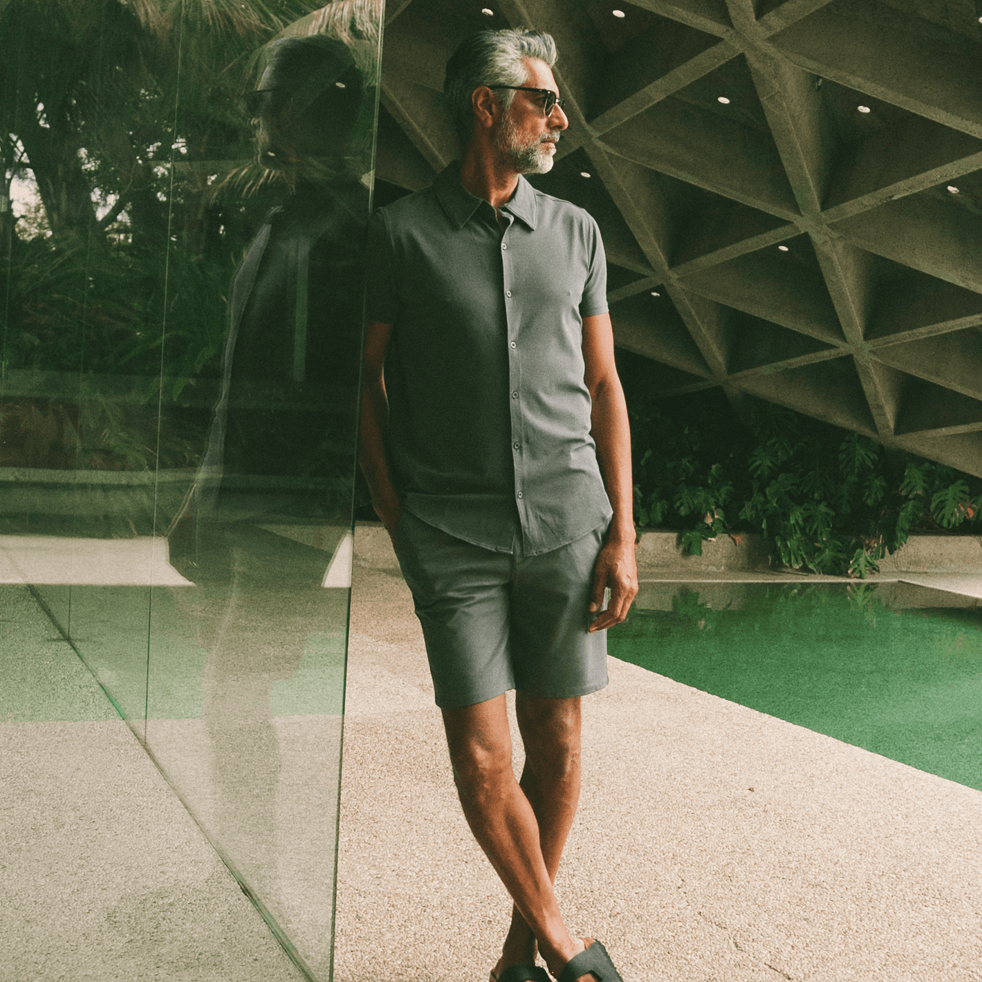 Man in Carbon 7.5 Inseam Chino Shorts by pool.