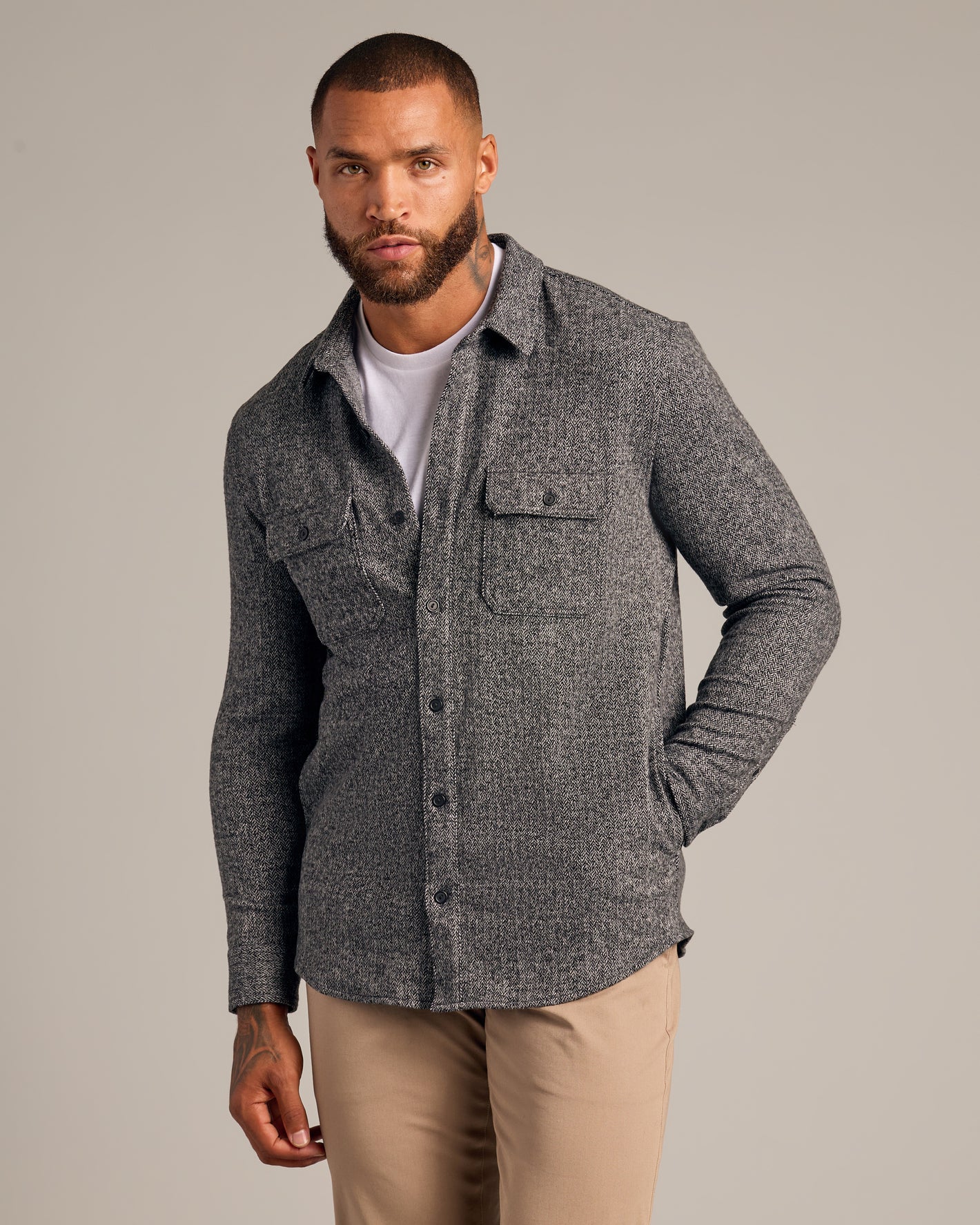 Black Sweater Shirt Jacket on model with chinos, highlighting herringbone texture.