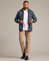 Model in Navy Sweater Shirt Jacket, open over white tee, with chinos.