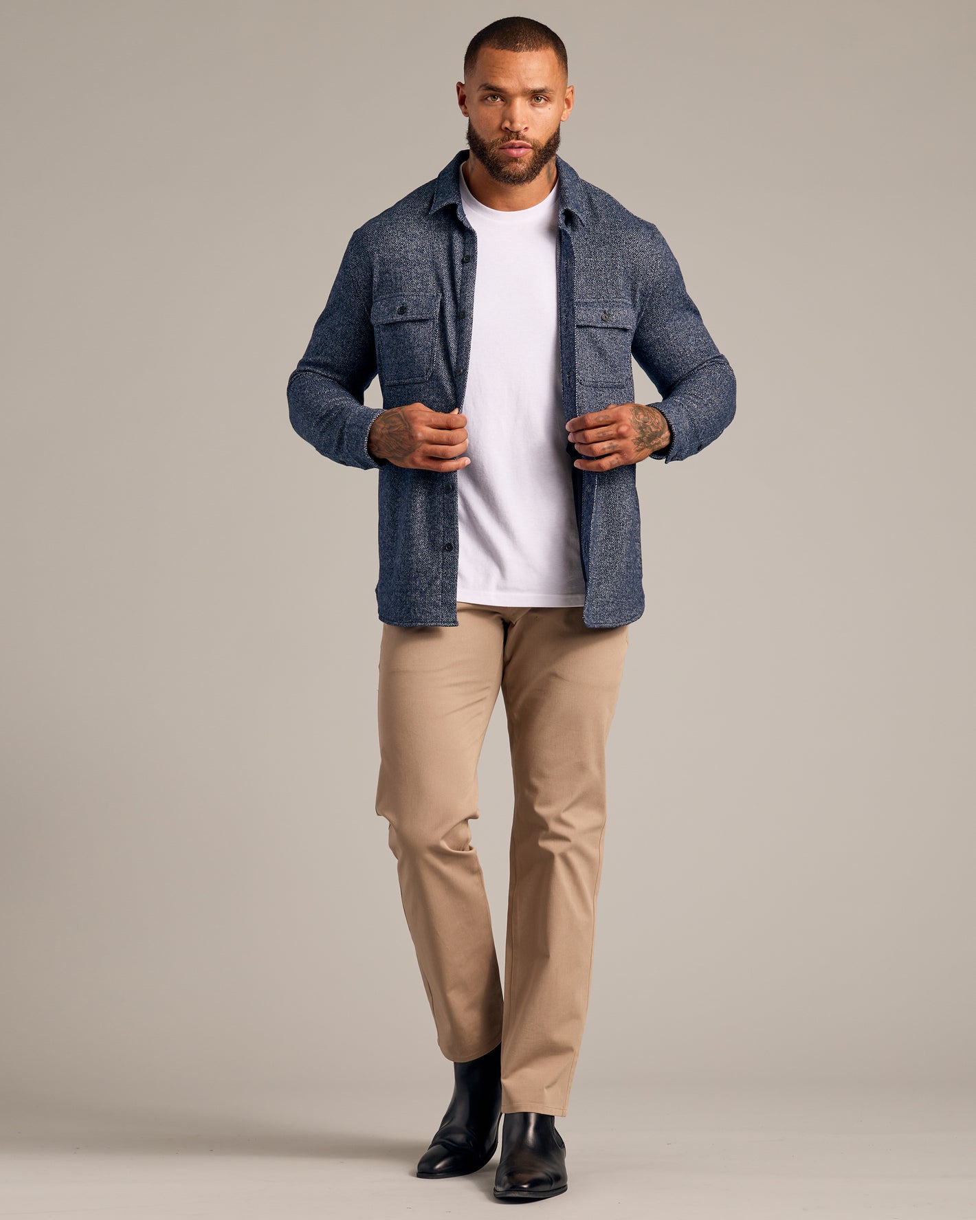 Model in Navy Sweater Shirt Jacket, open over white tee, with chinos.