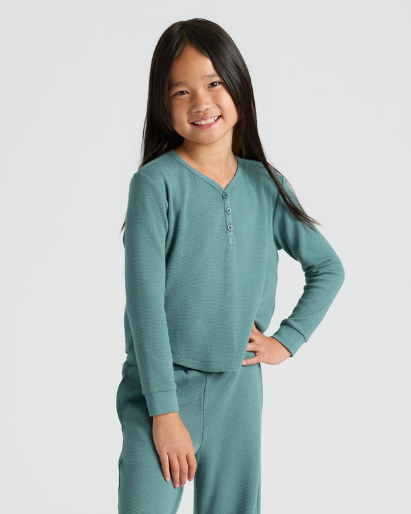 Girl wearing Girls Stormcloud Waffle Long Sleeve Henley & Waffle Leg Pants 2-Pack.