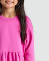 Girls Electric Fuchsia Long Sleeve Fleece Dress with gathered waist detail.
