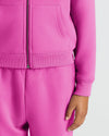 Girls Electric Fuchsia Cropped Zip Hoodie & Relaxed Joggers close-up view.