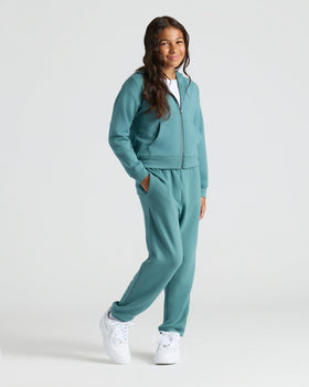 Girl in teal jogging suit wearing Girls Black & Stormcloud Cropped Zip Hoodie.