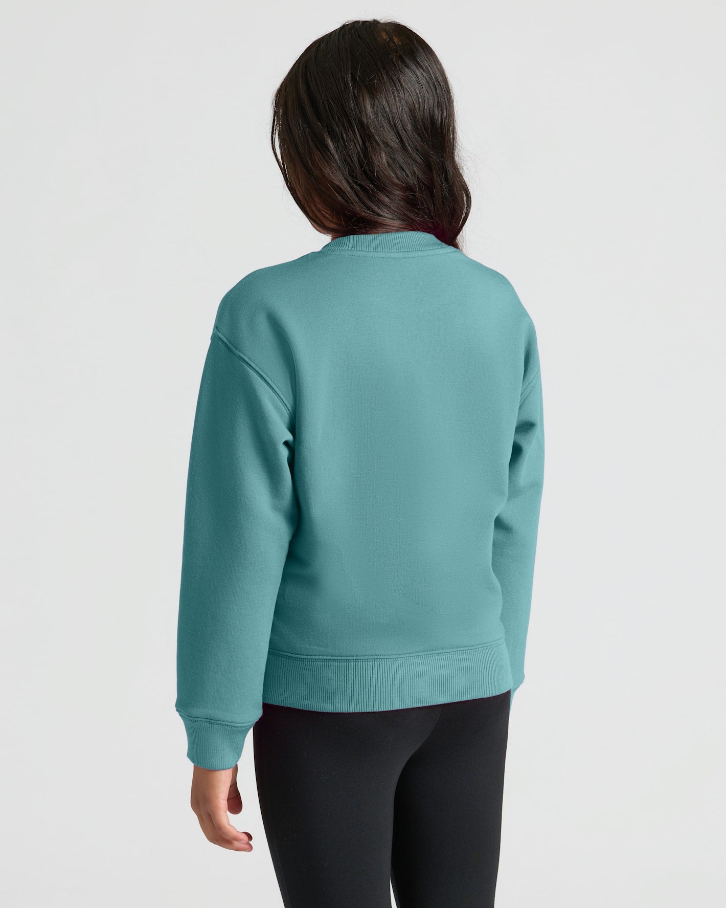 Girl wearing Girls Stormcloud Slouch Pullover Crew, back view, with leggings.