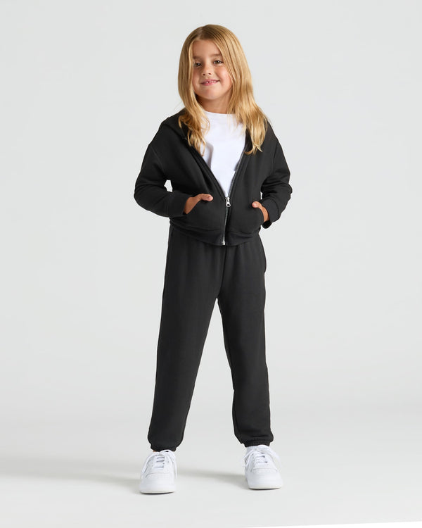 Child in black hoodie and Girls Deep Emerald & Black Relaxed Joggers.