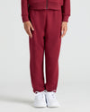 Girls Dark Maroon Cropped Zip Hoodie & Relaxed Joggers, child wearing sneakers.