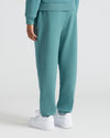 Girls Stormcloud Relaxed Joggers with classic white sneakers in a studio.