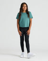Girl wearing Girls All Black Foldover Legging 2-Pack with teal T-shirt.