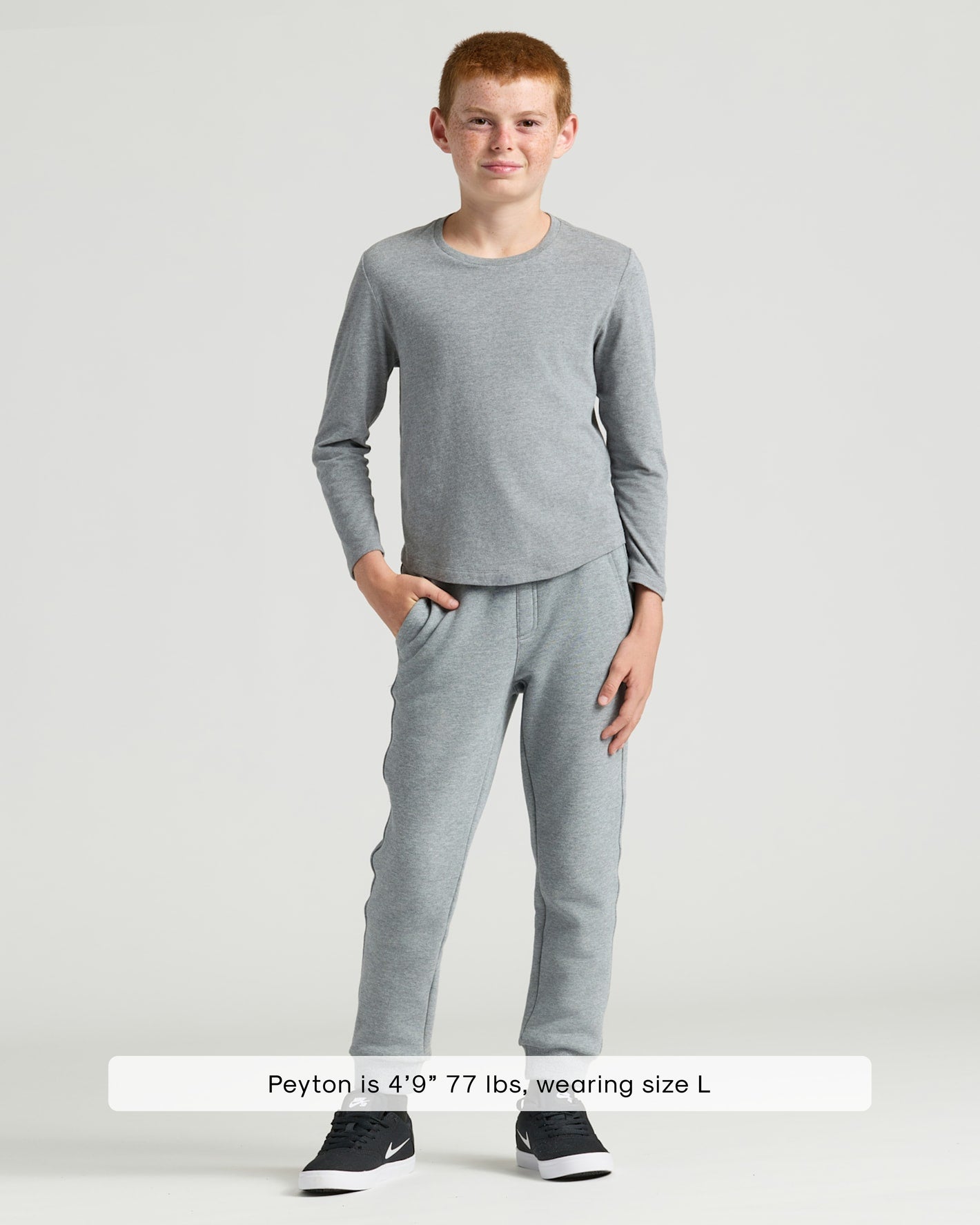 Boy wearing Boys' Heather Gray Classic Long Sleeve Crew Neck and gray sweatpants.