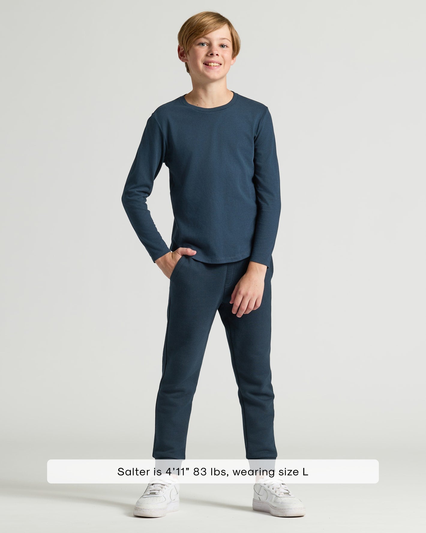 Boy wearing Boys' Navy Classic Long Sleeve Curved Hem Crew and jogger pants.