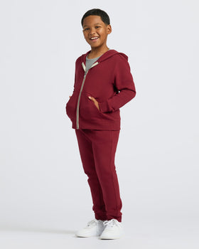 Boys Dark Maroon Full Zip Fleece Hoodie & Jogger 2-Pack worn by smiling child.
