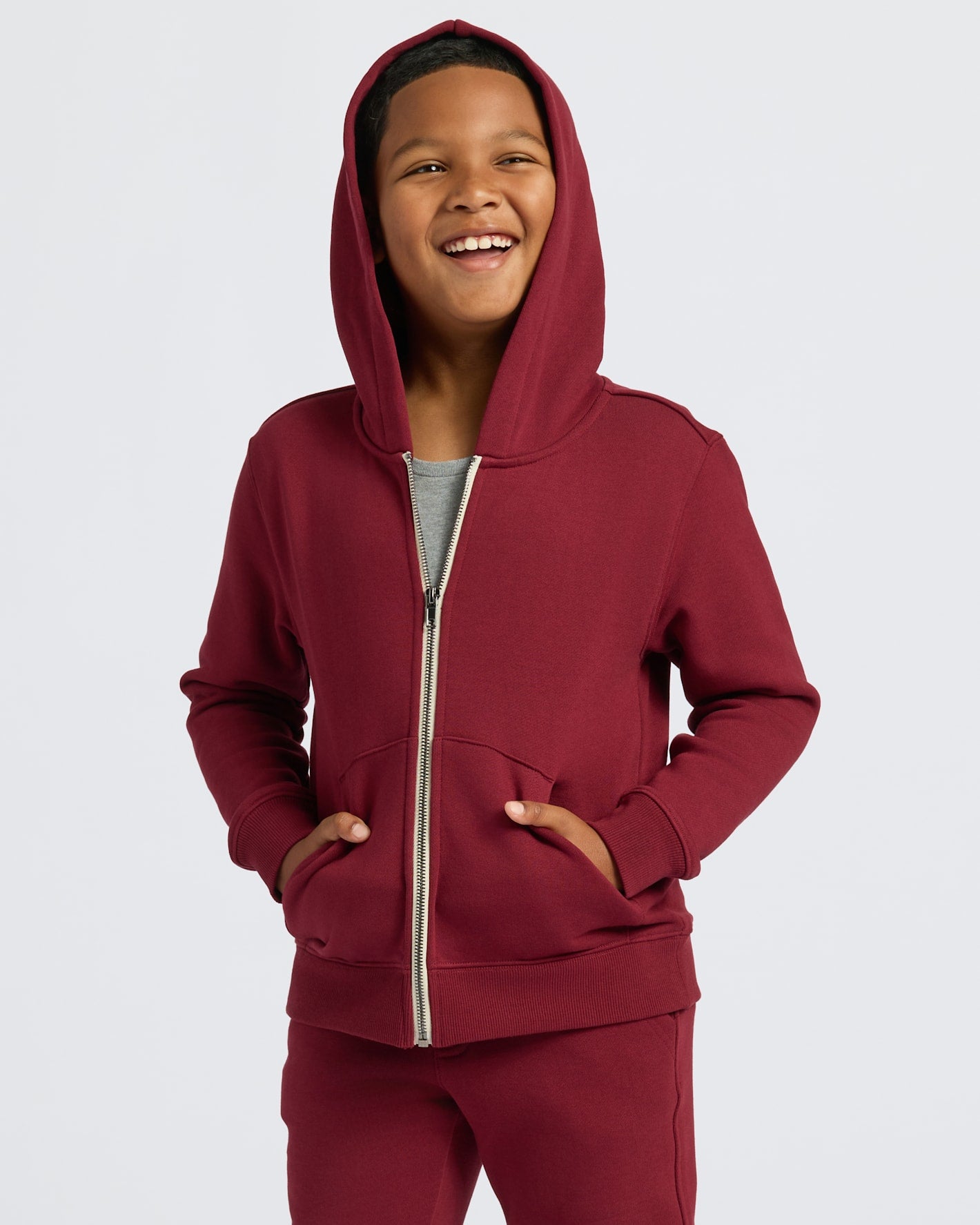 Boys' Dark Maroon Fleece Full Zip Hoodie worn by a smiling boy.