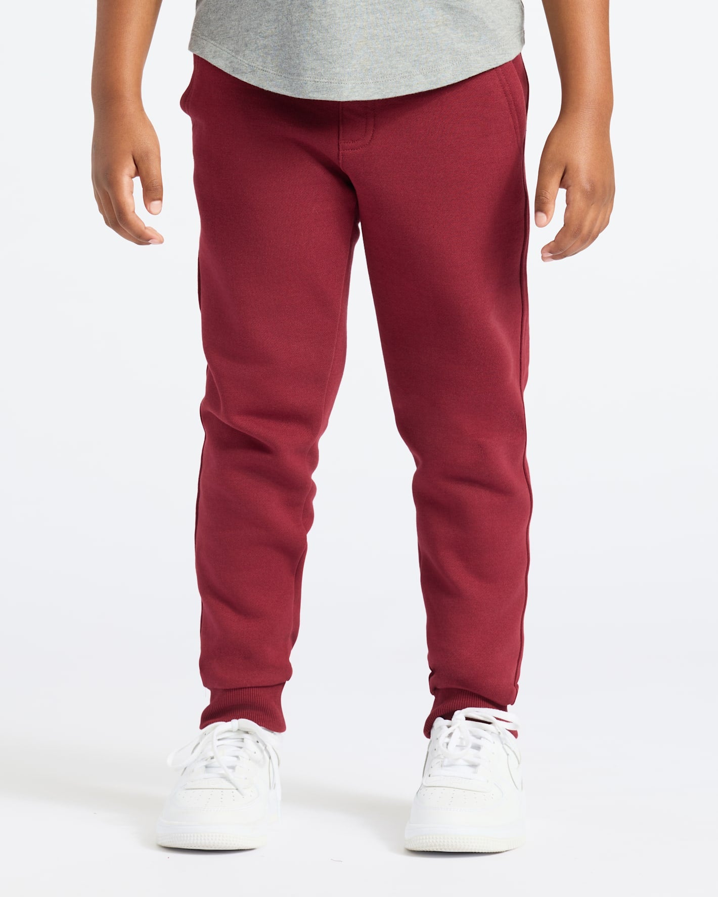 Boys' Dark Maroon Fleece Jogger with white sneakers.