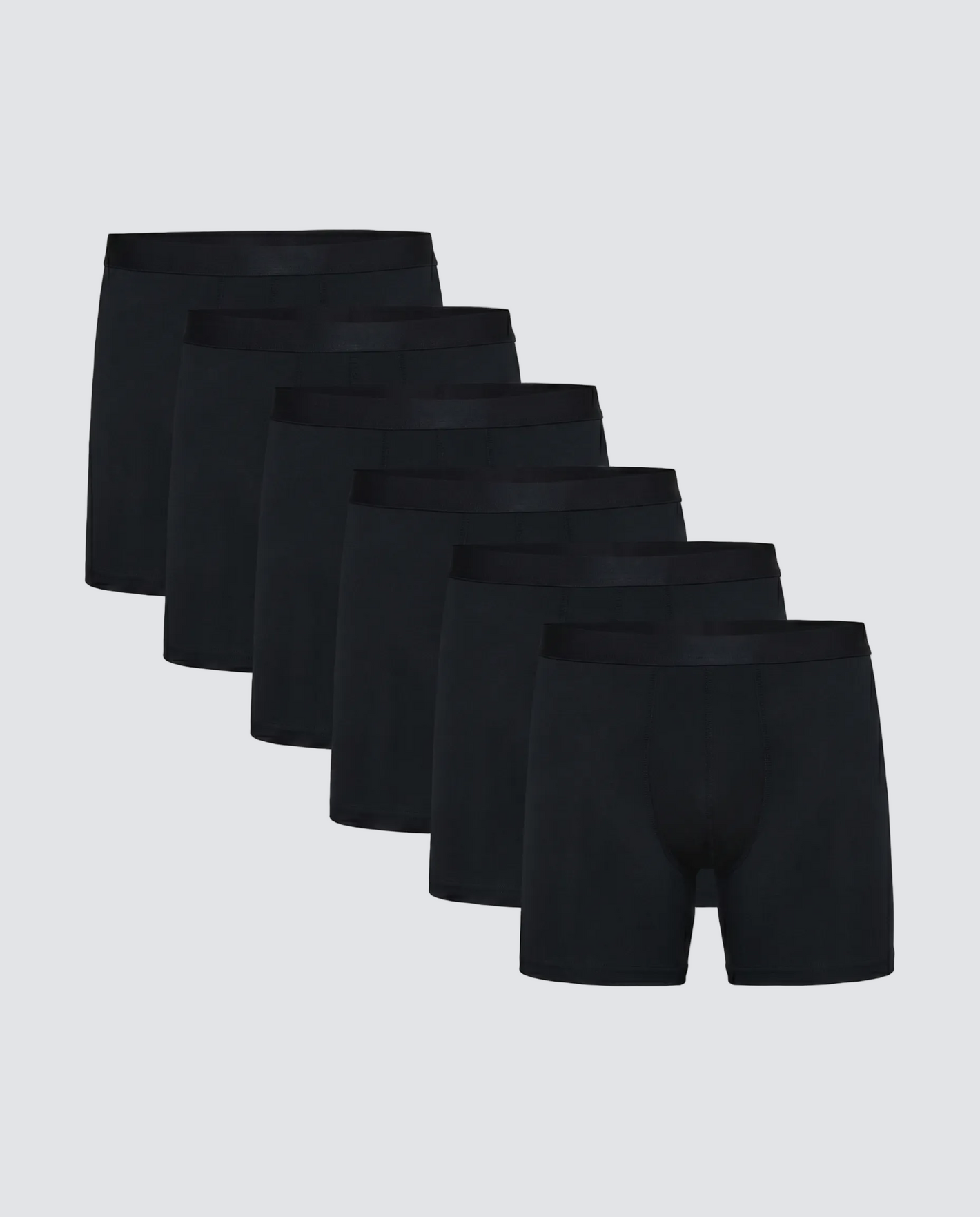 Set of six black boxer briefs on a light gray background