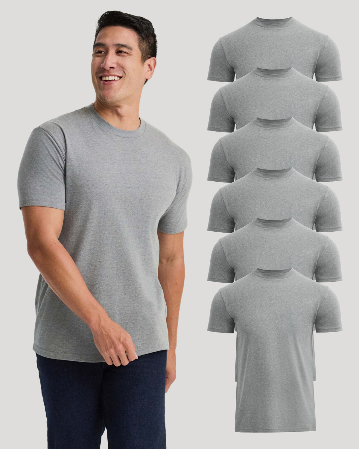 A smiling man wearing a light gray short-sleeve crewneck t-shirt, shown next to a vertical stack of seven identical t-shirts on a light gray background.