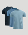 Three blue t-shirts in different shades on a light gray background