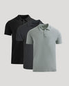 Three polo shirts in black and gray on a light gray background
