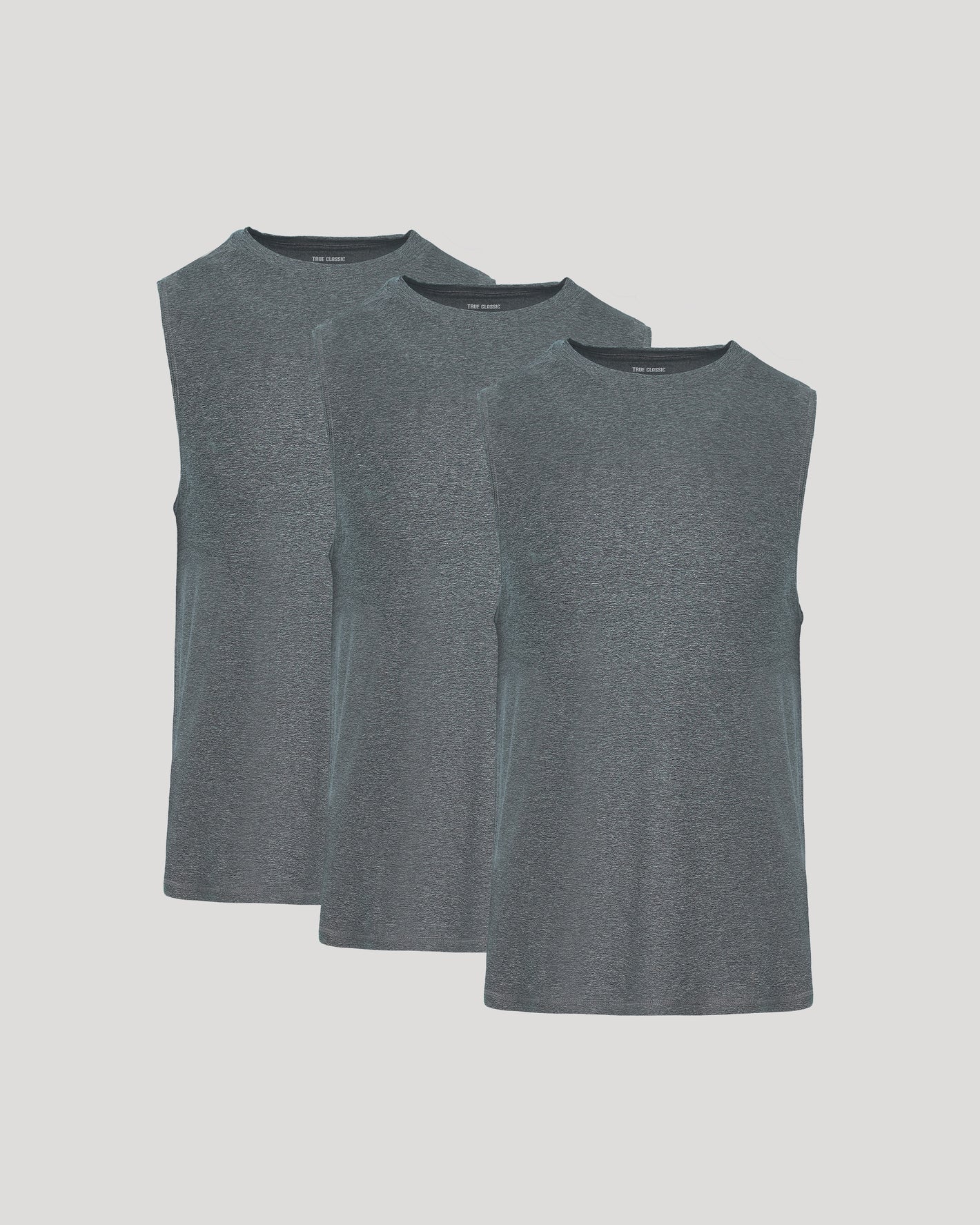 Three gray sleeveless shirts stacked on a light gray background