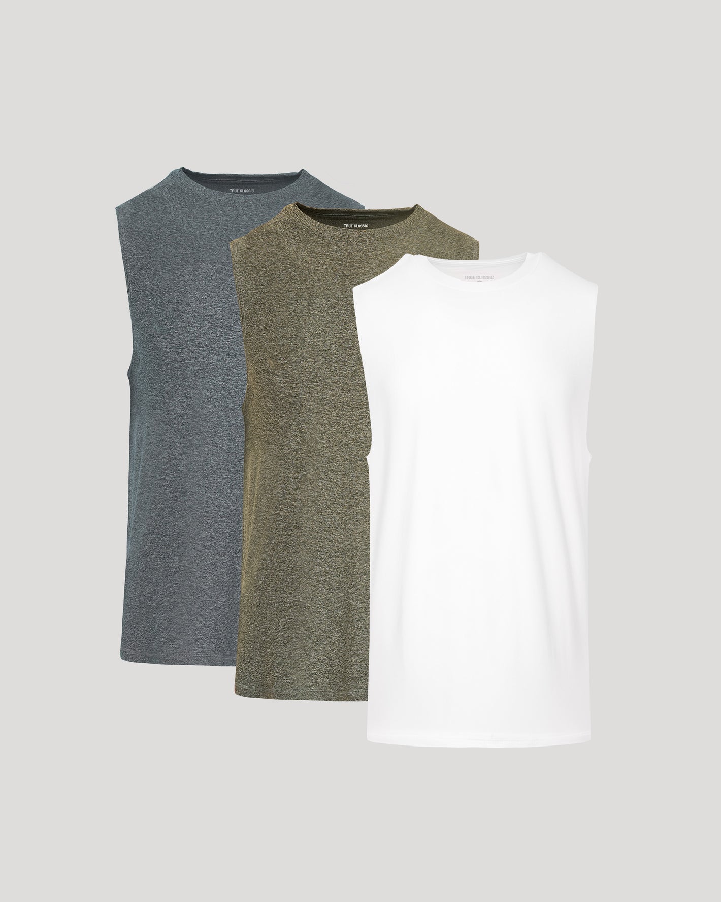 Three sleeveless shirts in gray, green, and white on a light gray background