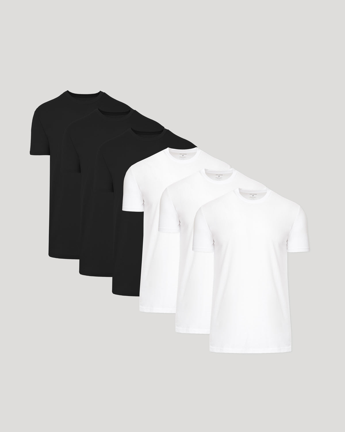 Five short-sleeve crew-neck t-shirts arranged in a fan shape on a light gray background, with three black shirts behind and two white shirts in front.
