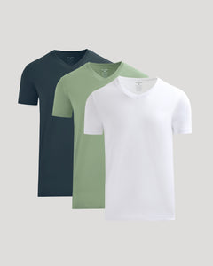 True ClassicThree plain t-shirts in navy, green, and white on a light gray background