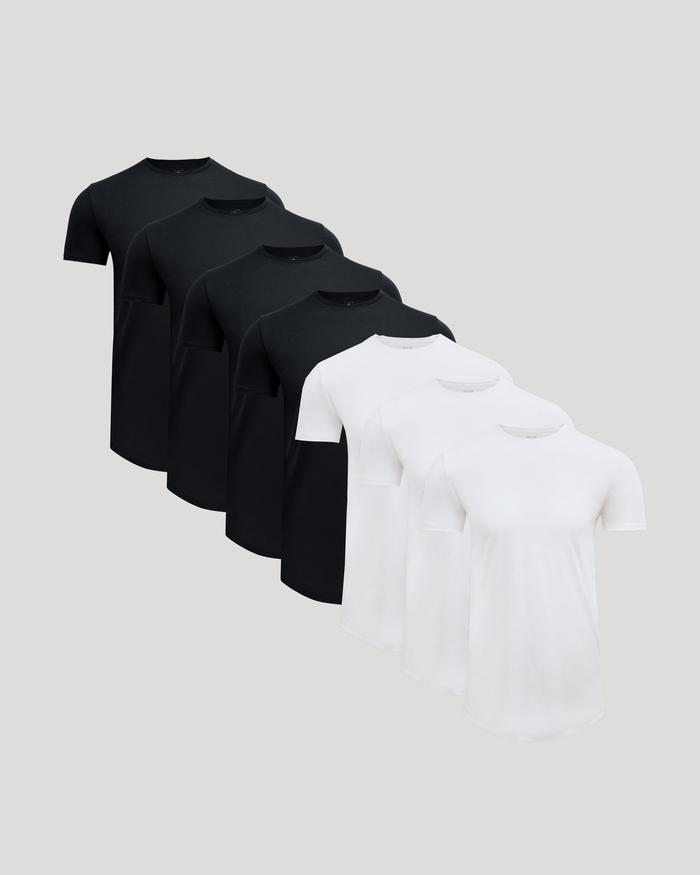 Seven men's basic crew neck t-shirts in black and white colors, designed with a curved hem, shown together as a Tall Pima Cotton Blend Curved Hem Crew 7-Pack.