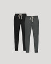Navy and gray sweatpants with drawstrings on a light gray background