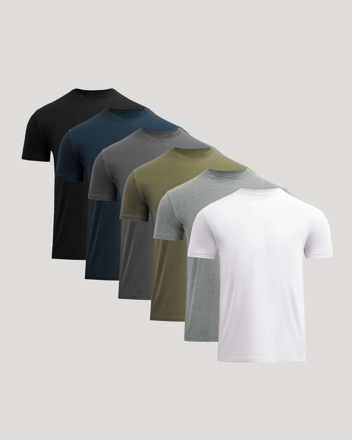 Set of five plain t-shirts in black, navy, gray, green, and white on a light gray background