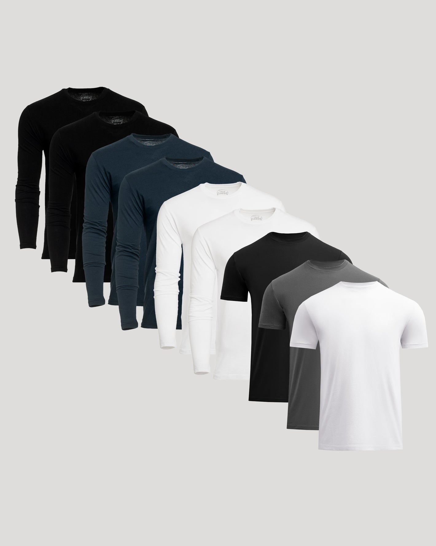 Set of men's long-sleeve and short-sleeve shirts in black, navy, white, and gray on a light gray background.