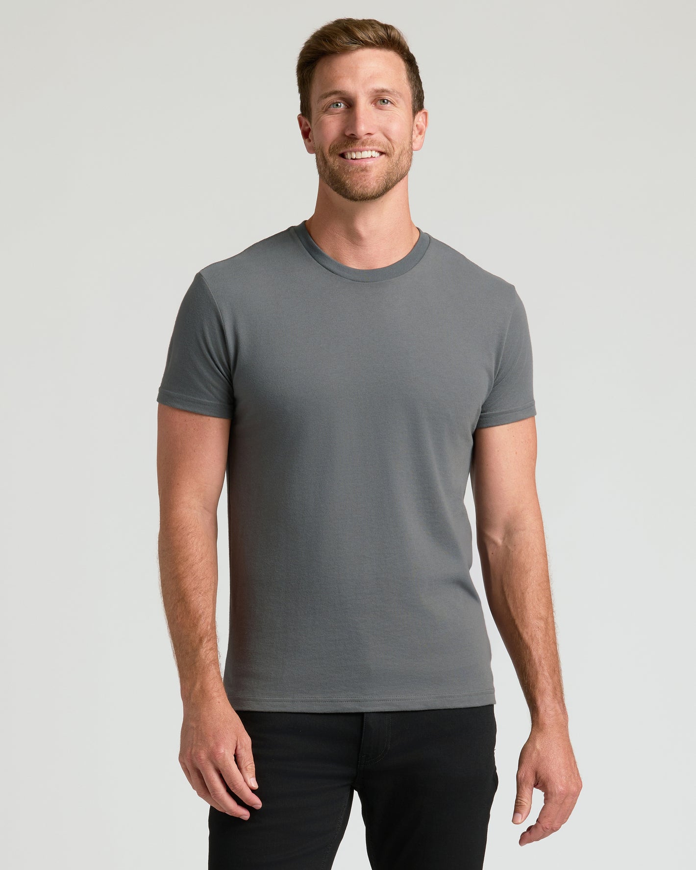 Man wearing Seasonal Classic Crew 10-Pack gray T-shirt, smiling.