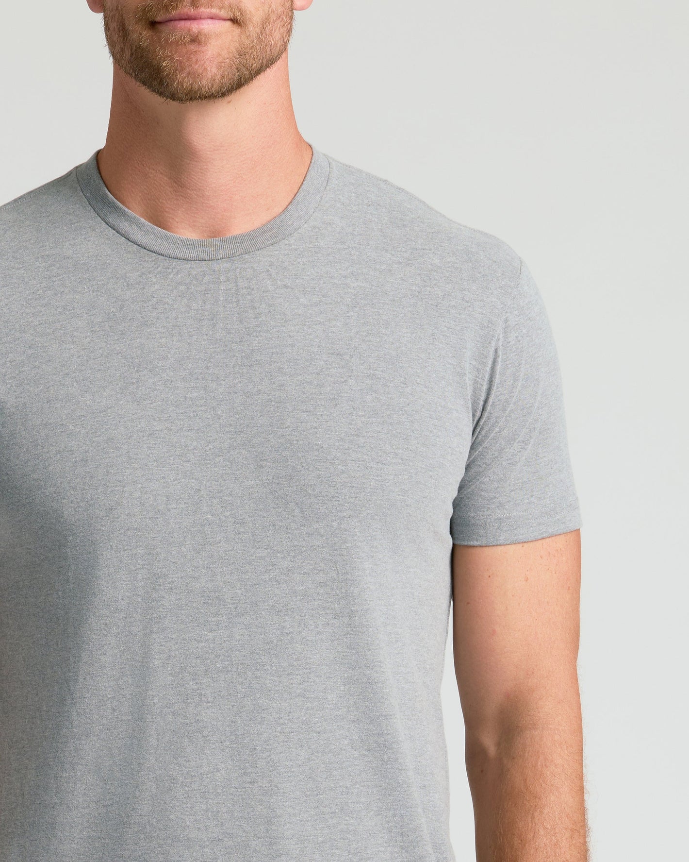 Man wearing Heather Gray Classic Crew Neck T-shirt.